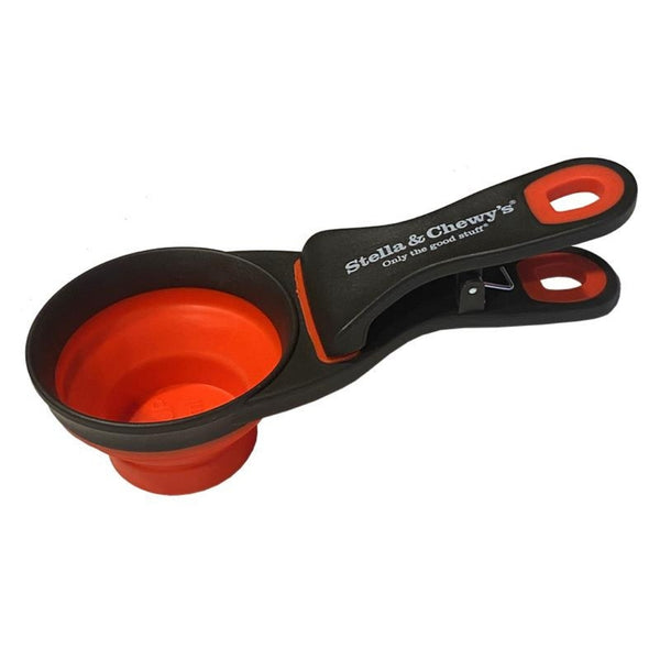 Collapsible pet food scoop with black handle and red basin on a white background, branded 'Stella & Chewy's'.