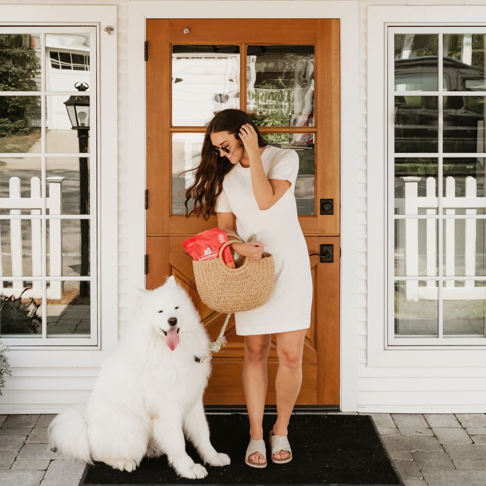 dog mom and her samoyed on the front porch